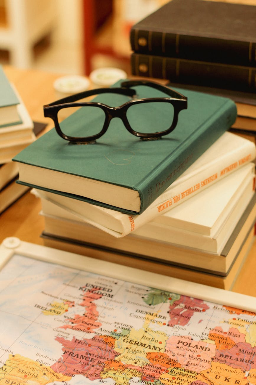 eyeglasses on books by map